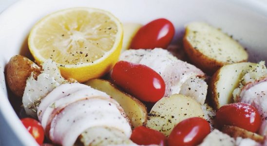 Cod baked in the oven with potatoes, tomatoes and bacon